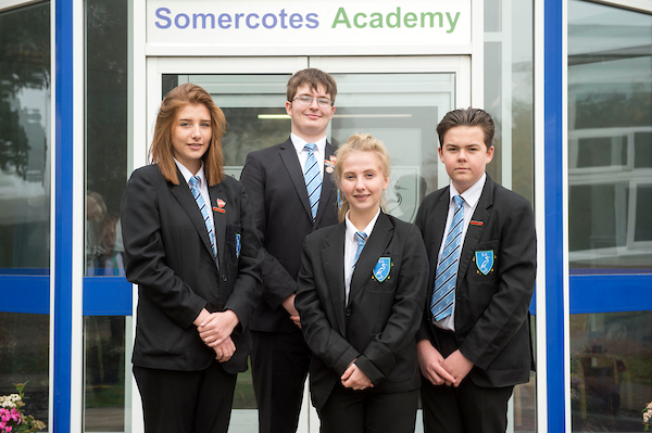 A boy and a girl student stood wearing the academy upper school uniform